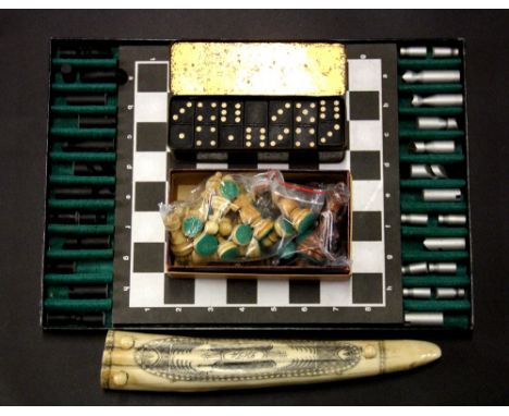 Two chess sets, cribbage board and a tin of dominoes.