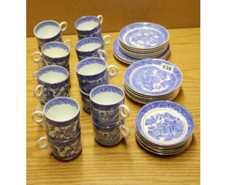An extensive quantity of willow pattern coffee cups and saucers.