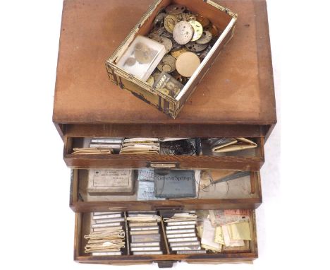 Four drawer chest containing a quantity of mainsprings (one drawer missing); together with a quantity of wristwatch and pocke