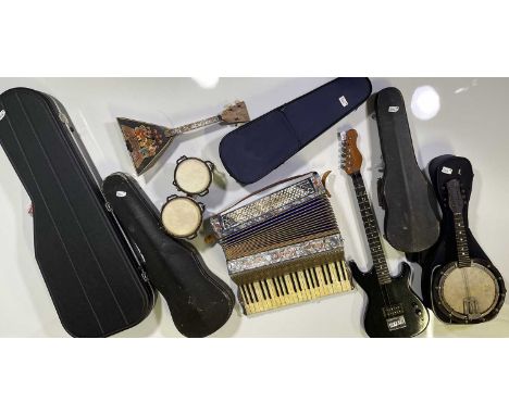 A collection of musical instruments to include a Westfield bass guitar, a Westfield Les Paul style guitar, and an unbranded b