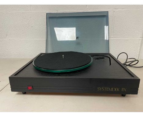 A Systemdek IIX record player with glass platter, original box and instruction manual included. Tonearm not included.