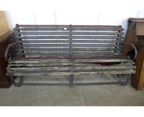 A Victorian wrought iron garden bench 