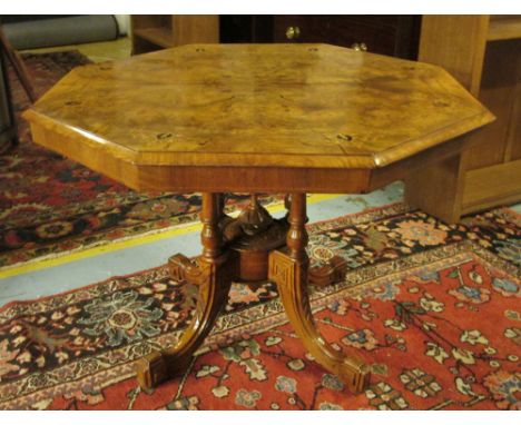 CENTRE TABLE, late Victorian walnut inlaid with an octagonal top on turned column supports centred with a finial and swept fe