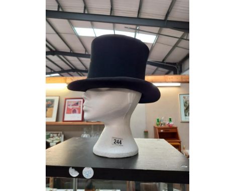 A vintage Hope brothers London top hat, some discolouration to parts of hat. Measurements 58cm circumference