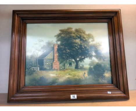 A large dark wood framed print of a log cabin under a tree