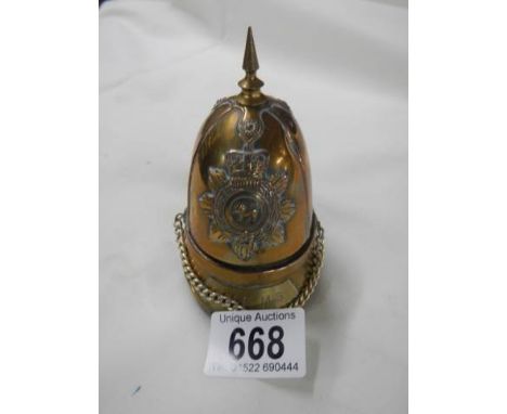 A cigarette lighter in the shape of a helmet.