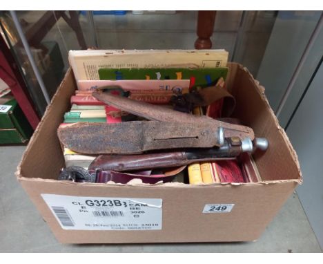 A box of vintage scouting books, badges, belt and knives