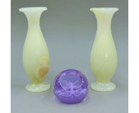 A pair of onyx vases and a Caithness paperweight. The former each 19 cm high.
