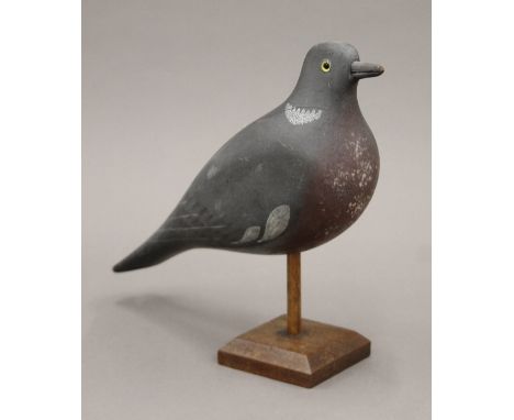 A vintage painted carved wooden pigeon decoy on stand. 32 cm long.