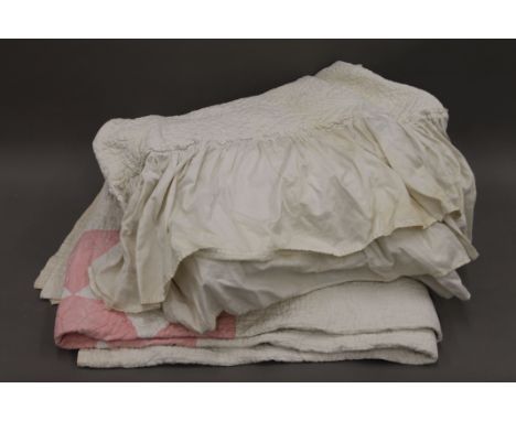 Two vintage quilts. The plain example approximately 175 x 165 cms, the other approximately 225 x 245 cms. 