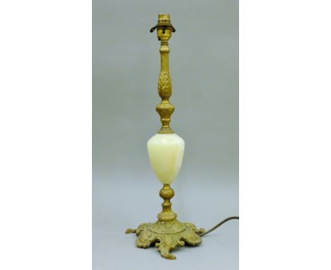 A gilt metal and onyx table lamp. 48 cm high.