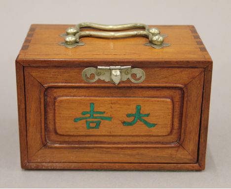 A small mahjong set, the ornate box containing bamboo and bone counters etc, with players' manual. The box 15.5 cm wide.