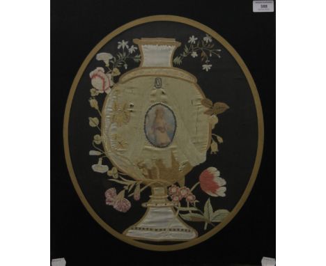 A 19th century gilt-framed and glazed silk work picture depicting a Flowering Urn centred with a Portrait of a Young Girl. 51