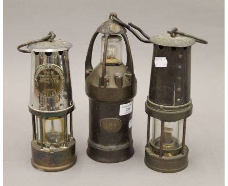 Three vintage miner's lamps.  The largest 27 cm high.