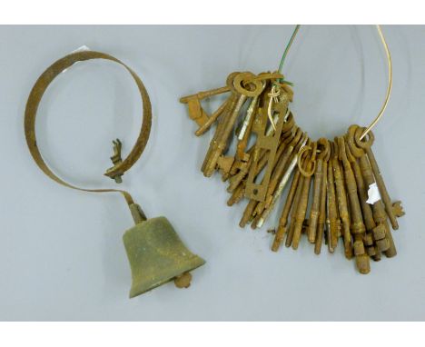 A bunch of vintage keys and a shop bell. The latter 23.5 cm high.