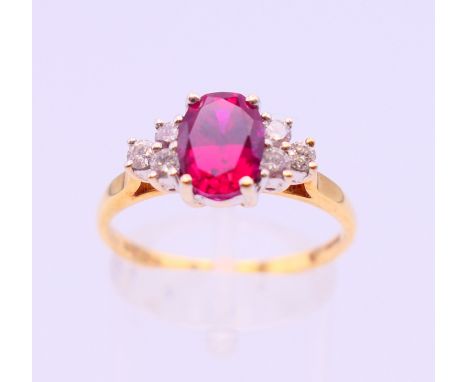 An 18 ct gold, diamond and ruby ring. Ring size S. 