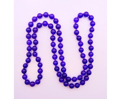 A string of lavender jade beads. 72 cm long. 