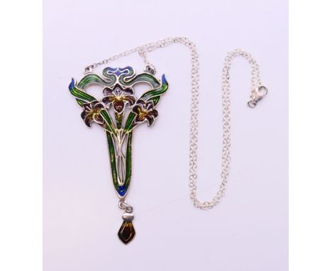 A silver Art Nouveau style pendant on a silver chain.  Pendant 7.5 cm high, chain 44 cm long. 