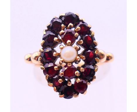 A 9 ct gold garnet and seed pearl ring. Ring size L.