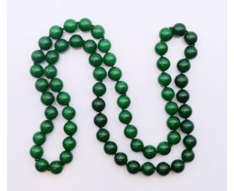 A string of jade beads.  82 cm long. 
