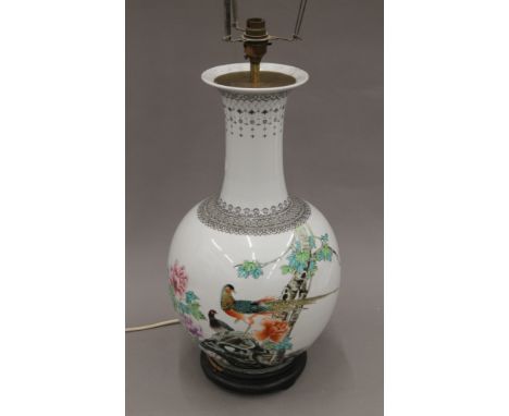 A Chinese porcelain lamp decorated with birds amongst floral sprays. 71 cm high overall.