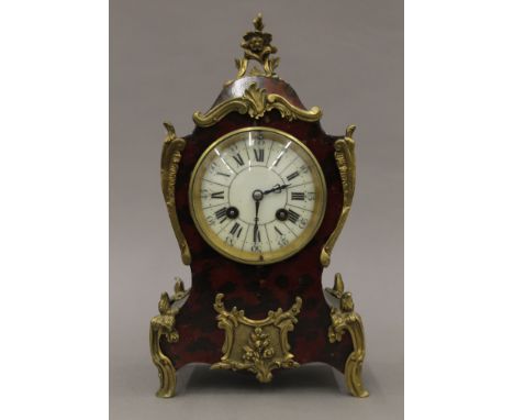 An early 20th century faux tortoiseshell mantle clock. 29 cm high.