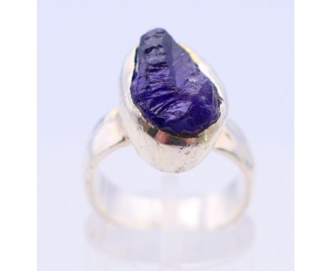 A handmade hammered silver ring, set with uncut amethyst. Ring size K/L.  
