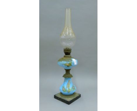 A 19th century painted blue glass oil lamp. 33 cm high excluding chimney.