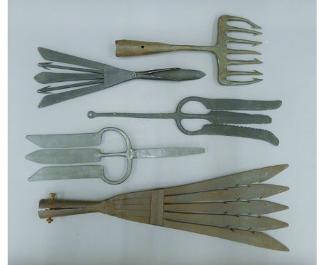 Five vintage eel gleaves, each lacking handle. The largest 57.5 cm long.