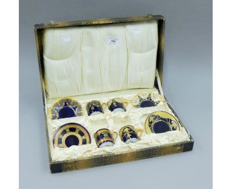 A part-cased set of Rosenthal porcelain coffee cans and saucers. The case 39 cm wide.