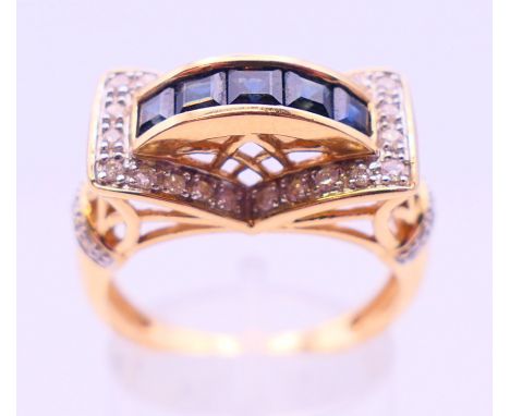 A 14 K gold, diamond and sapphire ring. Ring size R.