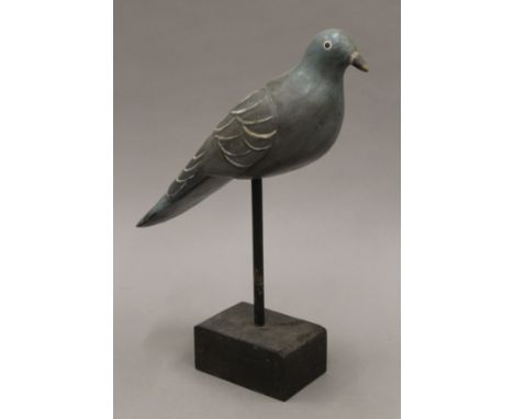 A vintage painted carved wooden pigeon decoy on stand. 35 cm long.
