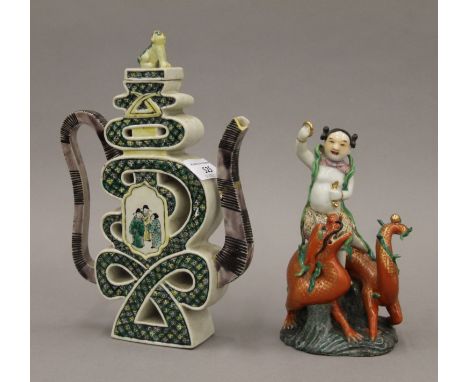 A Kutani teapot and a porcelain model of a girl and dragon. The former 24 cm high.