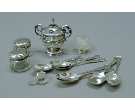 A small silver table lighter and three silver mounted jars and teaspoons. The former 6.5 cm high.