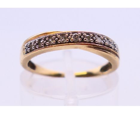 A 9 ct gold diamond ring. Ring size K.  