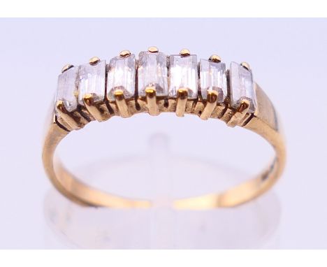 A 9 ct gold baguette set ring. Ring size J/K. 