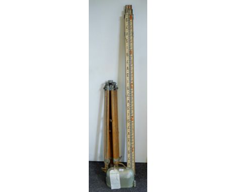 A mid-20th century A H Hall & Bros of London No 61784  Dumpy level on tripod and ranging staff. The level 25 cm long.