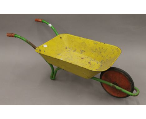 A vintage child's wheelbarrow. 82 cm long.