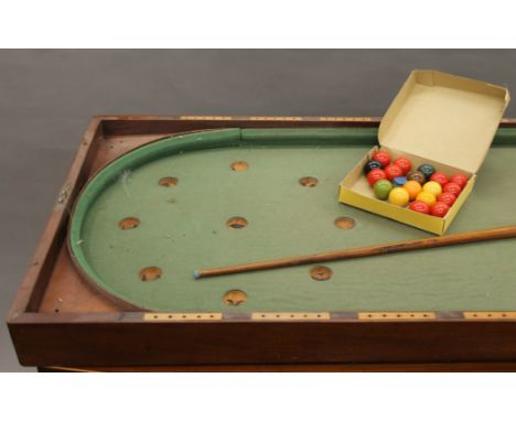 A Victorian mahogany folding bagatelle board with later balls. 57 cm wide x 244 cm long when open.