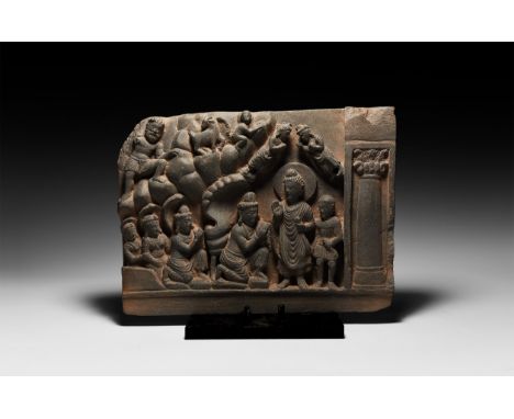 2nd-3rd century AD. A carved schist rectangular panel depicting Buddha standing wearing a simple draped robe, with&nbsp;aureo