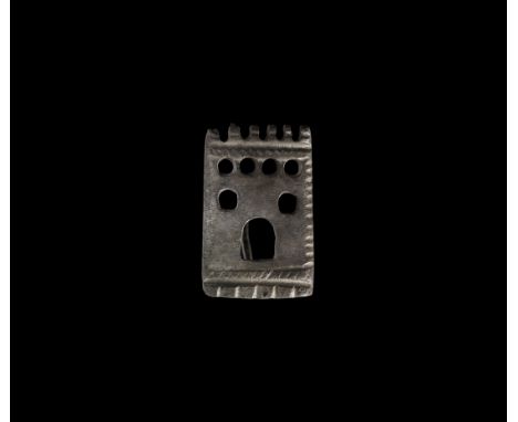 2nd century AD. A silver plate brooch formed as a fortified gate with crenellation to the upper edge, loopholes, arched doorw