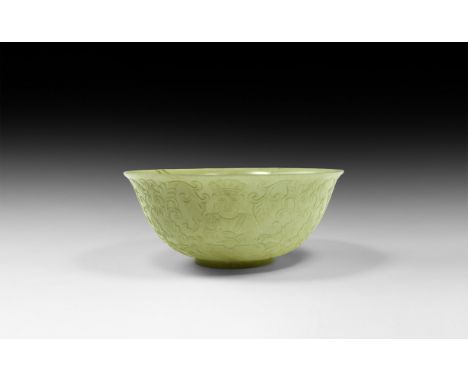 Qianlong Emperor, 1735-1796 AD. A carved translucent jade bowl with basal ring and flared rim, the outer face with four facin