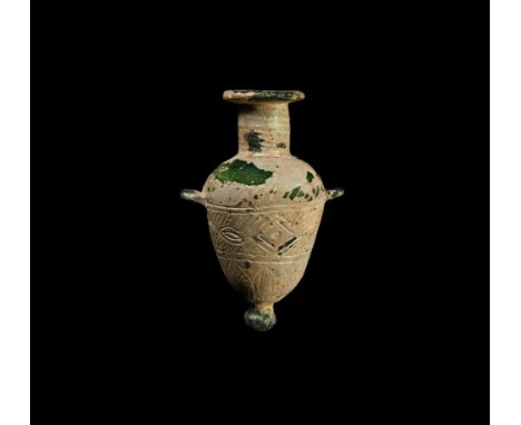 6th-4th century BC. An amphoriskos with two lug handles, broad, flat rim and knop finial at base; ribbed neck, guilloche at t