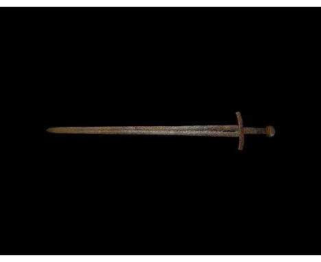 12th century AD. A hand-forged iron sword with slender blade and shallow fuller to each face, shallow point, gently curved re