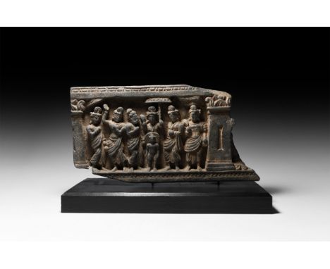 2nd-3rd century AD. A carved schist frieze panel with flanking columns, groups of standing figures including three dancers in