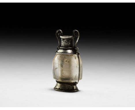 1st-2nd century AD. A perfume container formed as a miniature amphora with rock crystal body held by silver wires to a flared