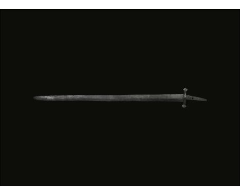 7th-10th century AD. A hand-forged single-edged iron sword with thickened straight back, angled flat-section tang, separate i