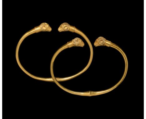4th century BC. A matched pair of gold penannular bracelets, each a round-section shank with median carinated bulb, the separ