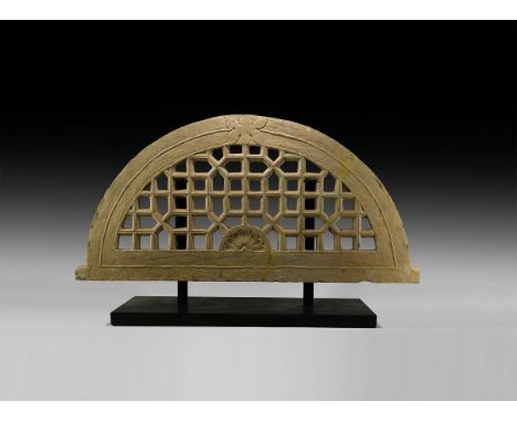 18th-19th century AD. A substantial sandstone architectural screen, D-shaped arch with lateral spurs to the base, central fan
