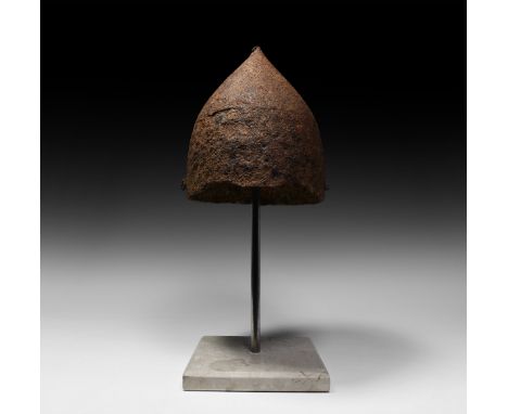 8th-11th century AD. A Norman or Viking period two-plate iron helmet, skilfully made to accommodate the curvature of the huma